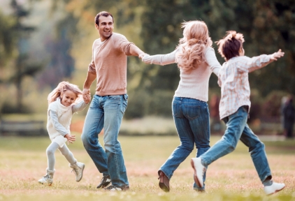 family playing in a park together