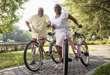 happy couple with bikes in a park