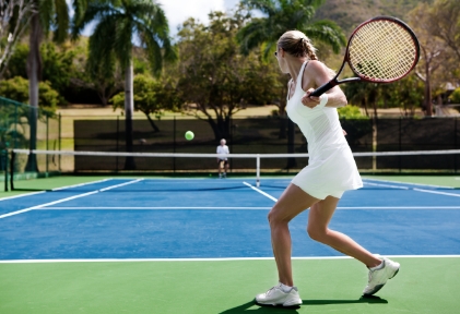 woman hitting a tennis ball